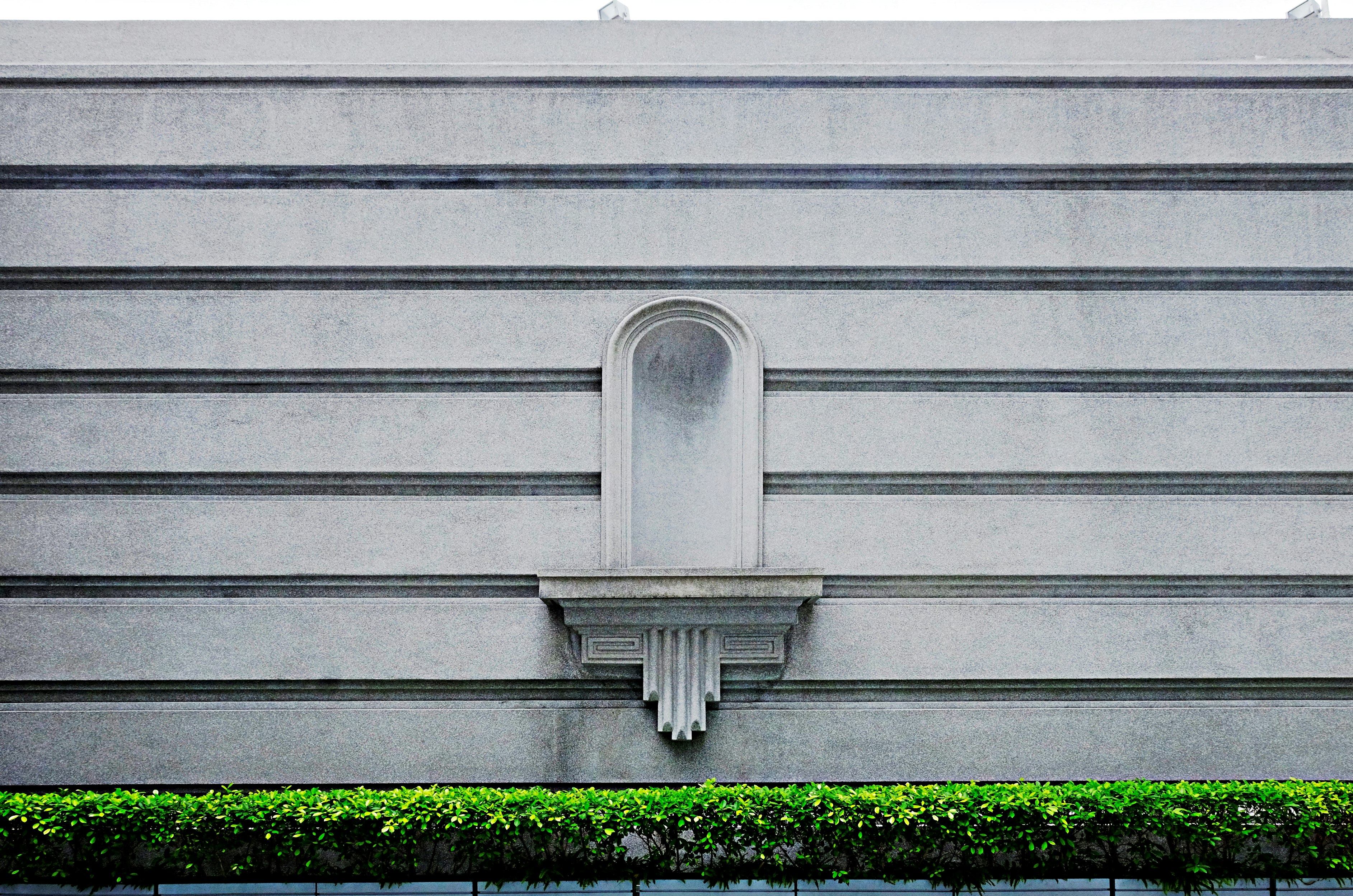 gray concrete wall with green grass